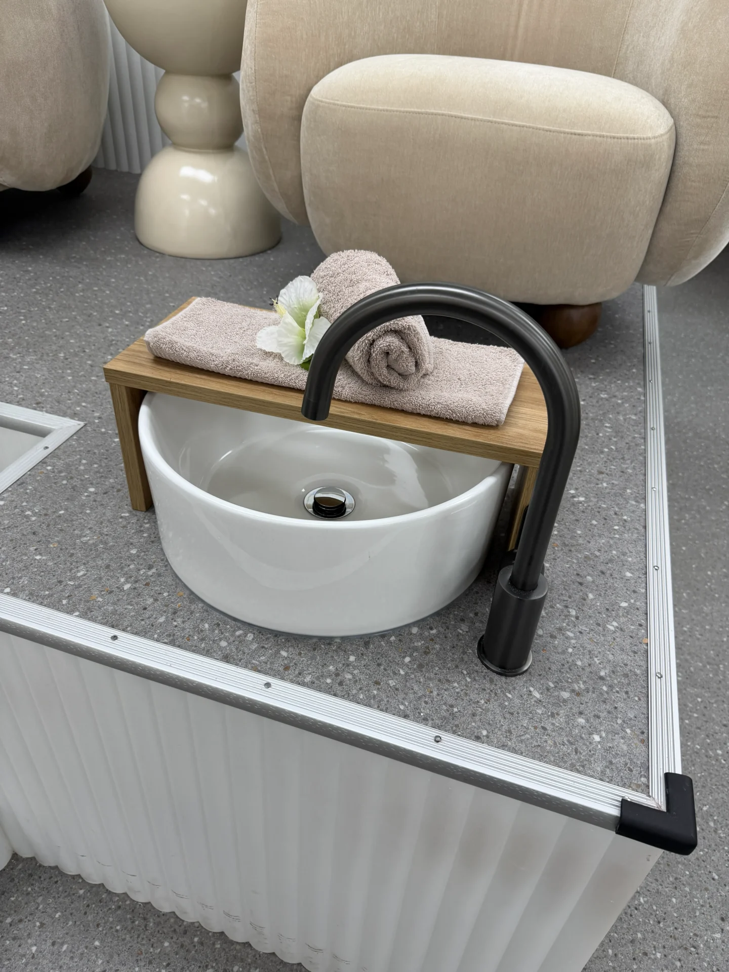 Spa-like foot bath setup with towel and flower