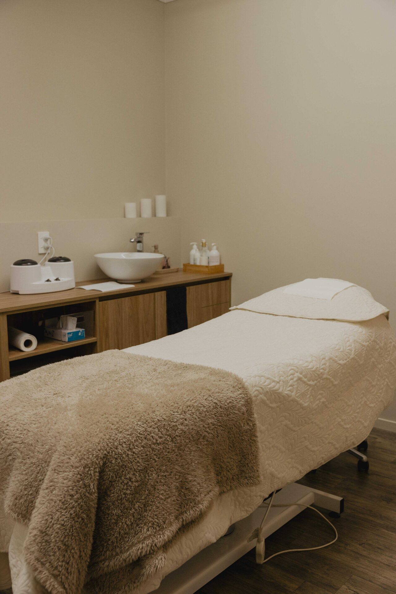 Cozy massage room with a treatment table.